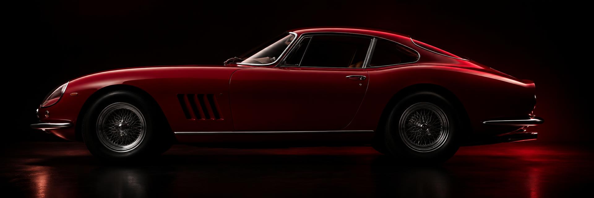 Red classic grand tourer in a dark studio